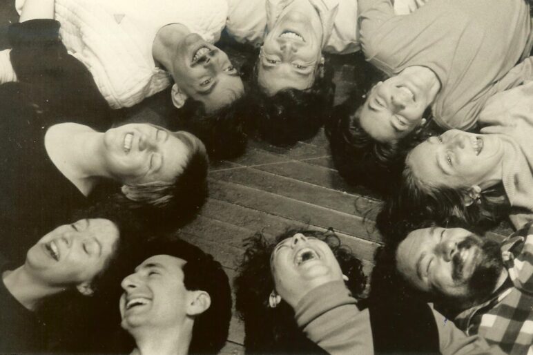 Participants in a circle laughing.